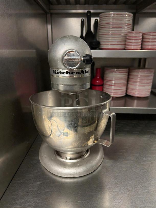 KitchenAid Artisan Stand Mixer, pristine condition, 5 Qt, 115V, silver finish, fully tested, with brand logo visible.