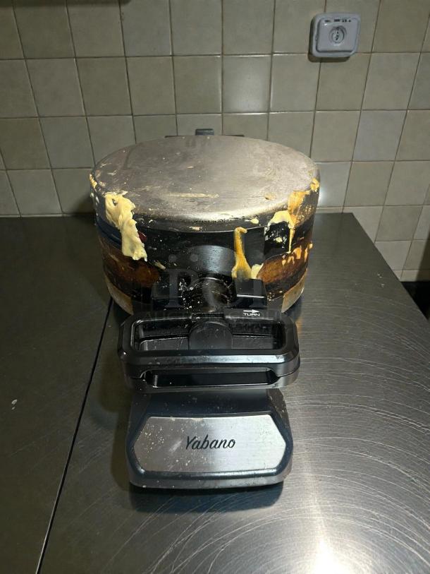 Yabano SW-2090B Belgian waffle maker, double rotating design, shown in working condition with batter residue.