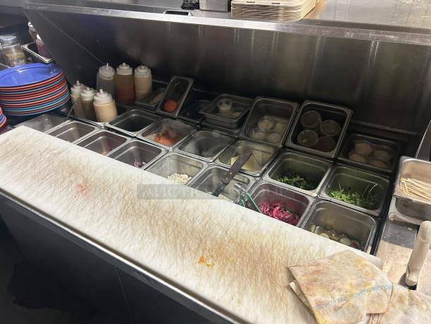 True TSSU-60-24M-B-ST-HC 60" sandwich prep table; holds 24 pans. Premium condition, tested, working, with visible cutting board.