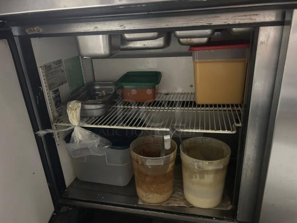 True TSSU-60-24M-B-ST-HC sandwich prep table; premium condition, fully tested; interior view with storage pans and shelves.