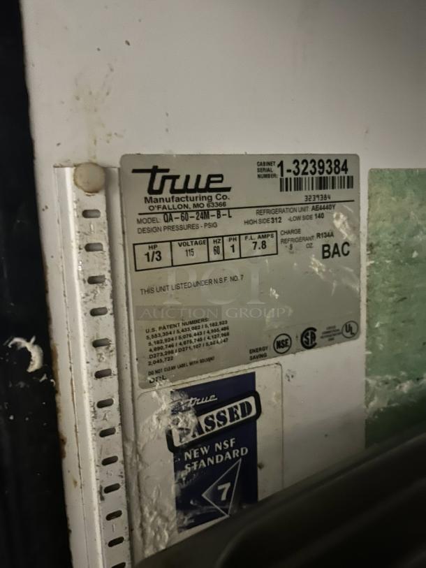 Close-up label of True Manufacturing Co. refrigerated sandwich prep table, model TSSU-60-24M-B-ST-HC, featuring serial number and NSF certification.