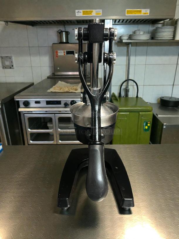Zulay Kitchen cast-iron manual orange juice squeezer, heavy-duty, robust condition, black finish, metal handle, functional.