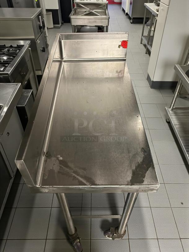 Omniteam 17" stainless steel worktop table with backsplash, casters; pristine condition, fully tested for functionality.