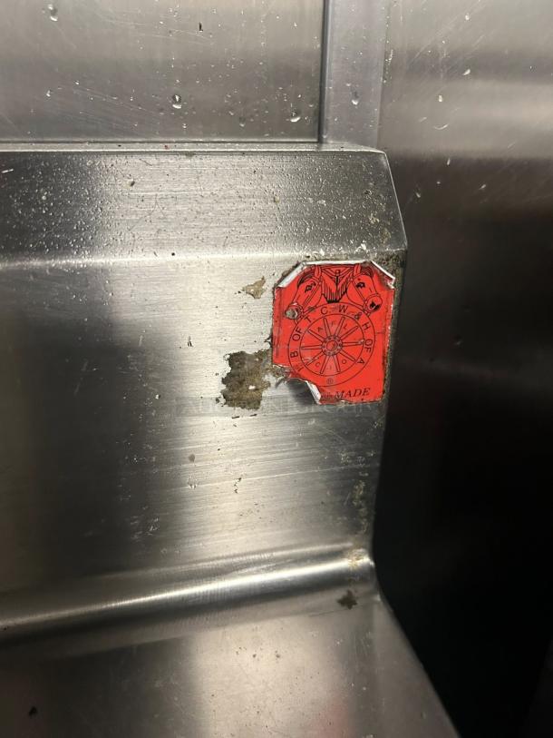 Omniteam 17" stainless steel worktop table with backsplash and casters. Features a red inspection sticker. Pristine condition.