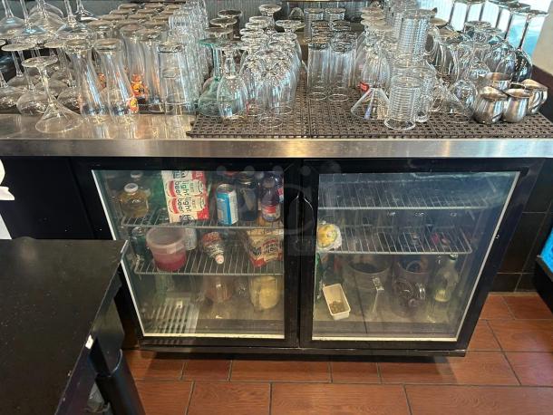 Dukers DBB60-H2 glass door refrigerated back bar cooler in pristine condition, fully stocked, and tested working.