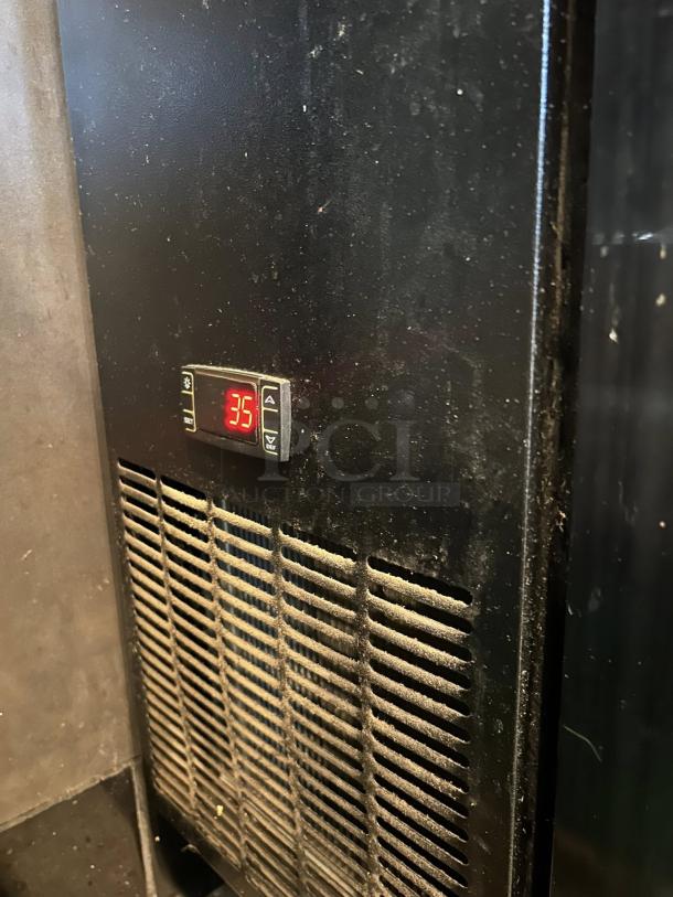 Dukers DBB60-H2 bar cooler in pristine condition, features digital temperature display showing 35°F, black exterior, fully tested.