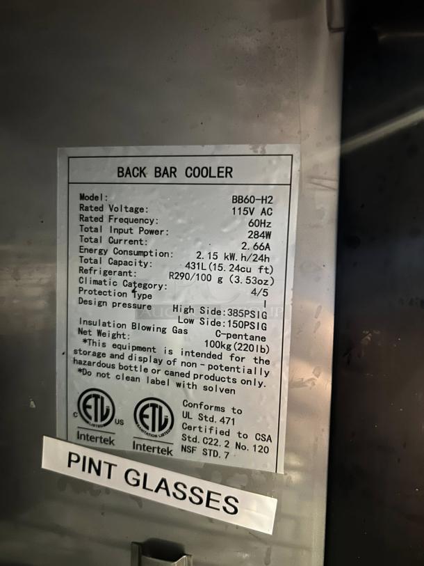 Dukers DBB60-H2 label. Glass door back bar cooler, 115V AC, 431L capacity, UL & ETL certified. Pristine condition.