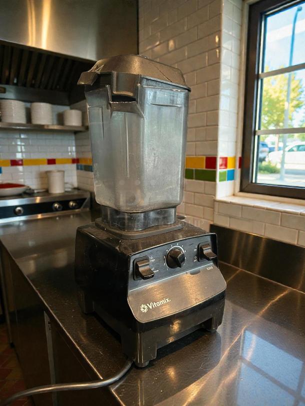Vitamix VM0197 Explorian Blender, 48 oz container, professional-grade, premium condition, tested and working, on stainless countertop.