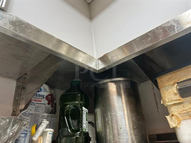 Immaculate stainless steel Omniteam corner wall shelves, 8x8 ft, L-shape, tested and ready for use, visible sturdy supports.