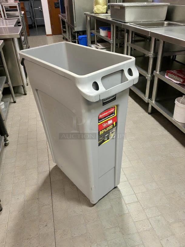 Rubbermaid Slim Jim 23-gallon grey trash receptacle in excellent condition; clean and ready for use, featuring brand label.