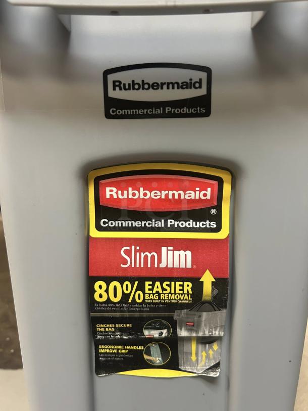 Rubbermaid Slim Jim 23-gallon grey trash receptacle. Immaculate condition, ergonomic handles, 80% easier bag removal label.
