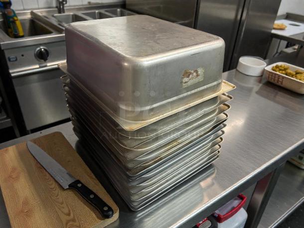 Stack of Carlisle DuraPan™ stainless steel hotel pans, model 607124, 1/2 size, 4" deep, in premium condition.