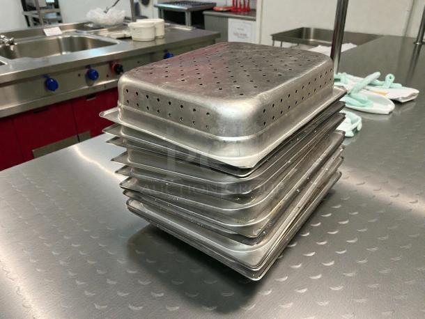 Stack of Carlisle DuraPan™ 607122P perforated steam table hotel pans, 1/2 size, stainless steel, 2.5" deep, pristine condition.