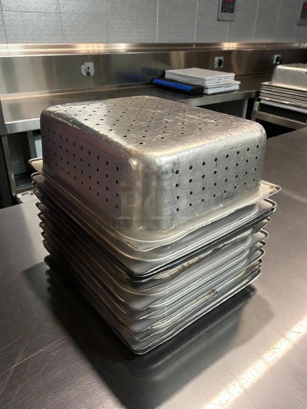 Thunder Group STPA3124PF 1/2 Size Perforated Steam Table Pan, 4" Deep, immaculate condition, stacked on metal counter.