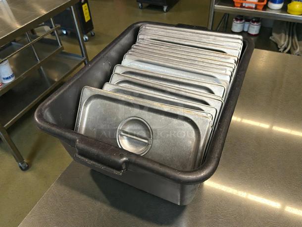 Thunder Group® STPA5130CS stainless steel slotted steam table pan covers in refined condition, 1/3 size, stacked in a bin.