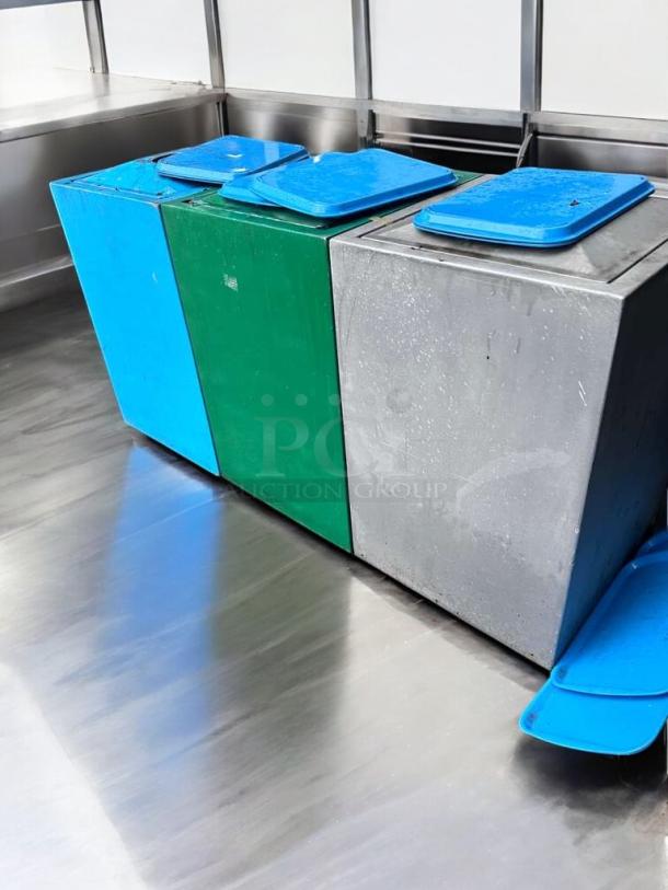 Commercial outdoor trash containers in immaculate condition, made of heavy-duty plastic, featuring blue and green bins with lids.