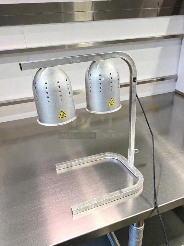 Dual head commercial heat lamp food warmer in stainless steel, tested and working, premium condition, with warning labels.
