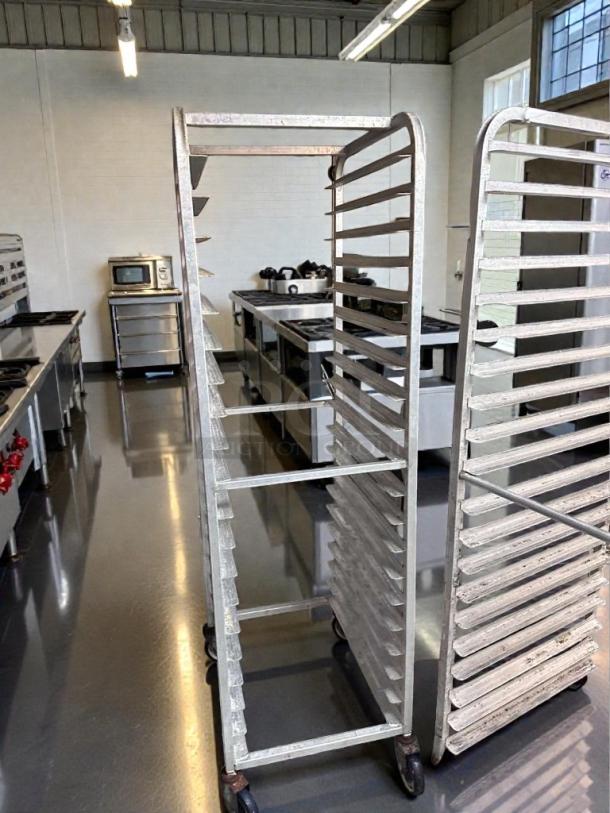 Pair of full-size aluminum speed racks for sheet pans, mobile, used but in superior condition, for commercial bakery use.