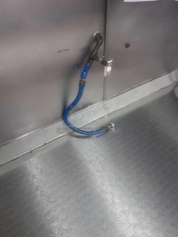 Commercial gas appliance connector hose, blue, in prime condition, inspected and ready for use, against a metallic background.