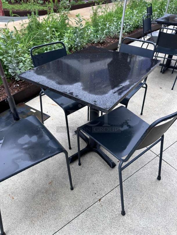 Pristine black metal outdoor patio table with two chairs, commercial model, ready for use, excellent condition.