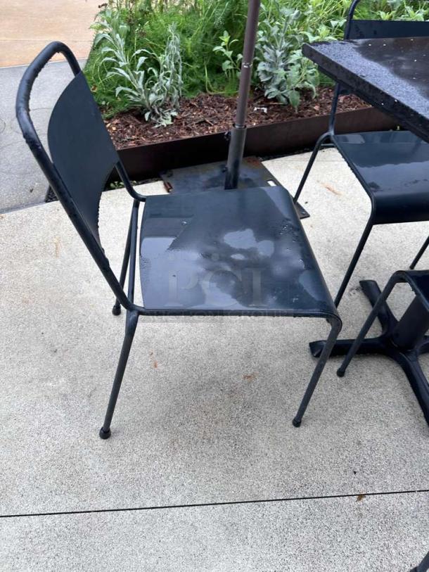 Pristine black metal patio chair from Commercial Outdoor Patio Set. Ready for use, part of table and chair set.