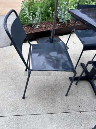 Pristine black metal patio chair from Commercial Outdoor Patio Set. Ready for use, part of table and chair set.