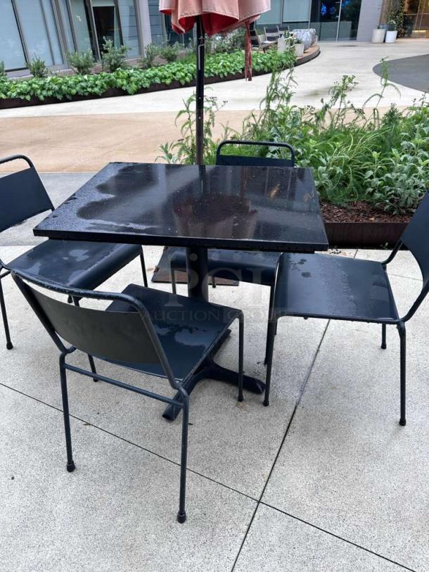 Pristine black metal patio table and chairs, commercial model, ready for use, includes one table and two chairs.