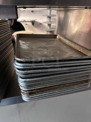 Stack of 18 commercial-grade aluminum half sheet pans in outstanding condition, showing minimal wear.