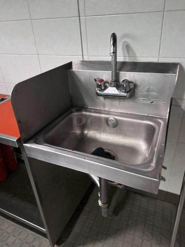 Commercial stainless steel wall-mounted hand sink with faucet and side splash. Outstanding condition, tested, ready for use.