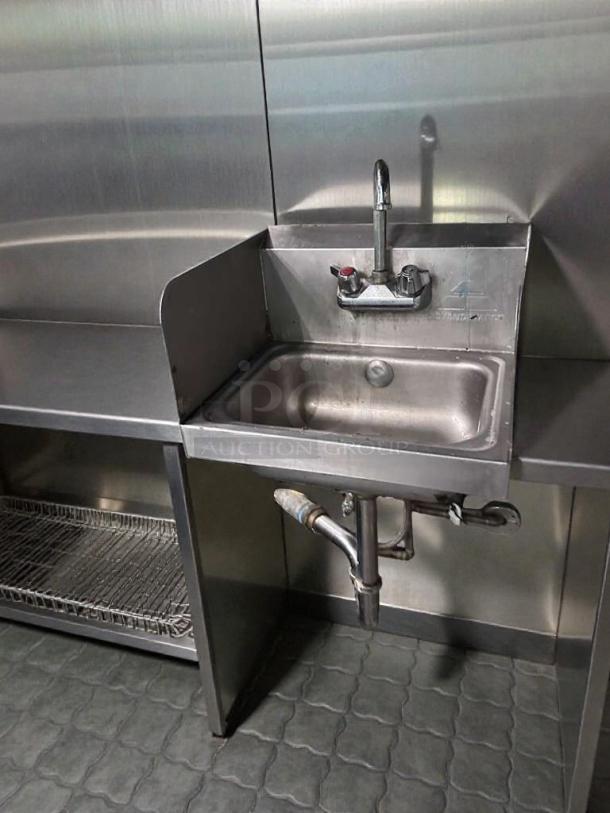 Industrial stainless steel wall-mounted hand sink with faucet and side splash, outstanding condition, tested, commercial use.