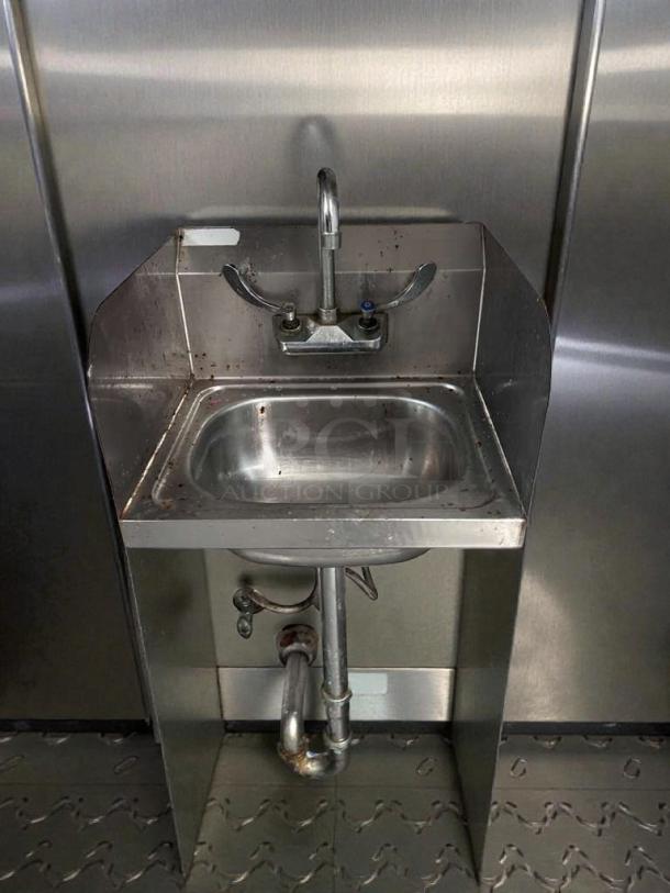 Like new stainless steel commercial hand sink, tested and working, features durable faucet and backsplash.