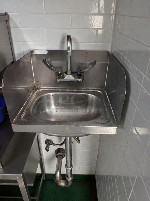Stainless steel commercial hand sink, like-new condition, tested and working, with backsplash and faucet, ideal for kitchens.