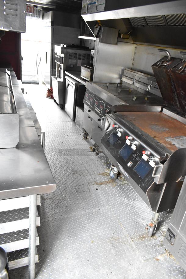 28' Wendy's fast food trailer interior featuring commercial-grade kitchen equipment, including grills, fryers, and coolers.