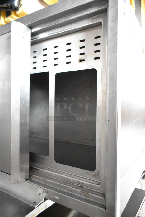 Metal compartment inside fully outfitted Wendy’s 28' food trailer featuring commercial-grade equipment in good condition.