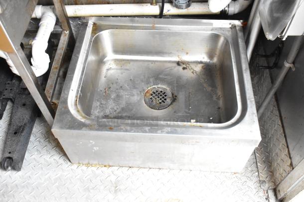 Stainless steel sink in 28' Wendy's fast food trailer, showing signs of use, set on diamond plate flooring.