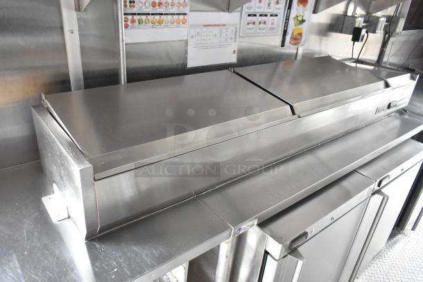 Commercial-grade kitchen setup inside Wendy's 28' food trailer, with stainless steel counters and various equipment shown.