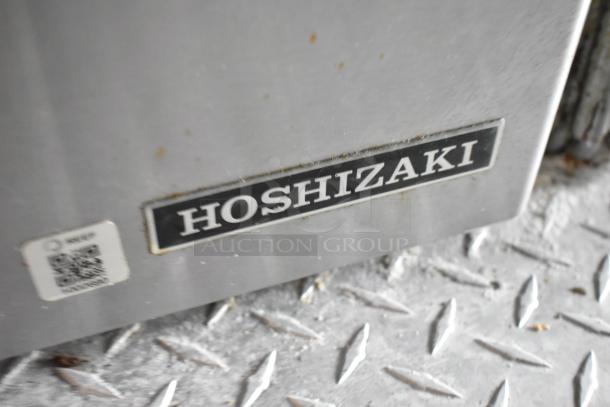 Label on metal surface reading "Hoshizaki" with visible QR code sticker, indicating equipment branding.