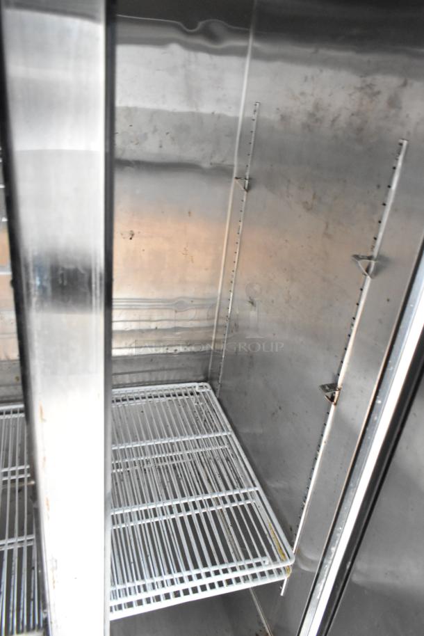 Interior view of Liebherr industrial cooler with metal shelving, showing clean condition and ample storage space.