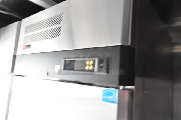 Close-up view of a commercial cooler unit inside a 28' Wendy’s fast food trailer, featuring temperature controls.