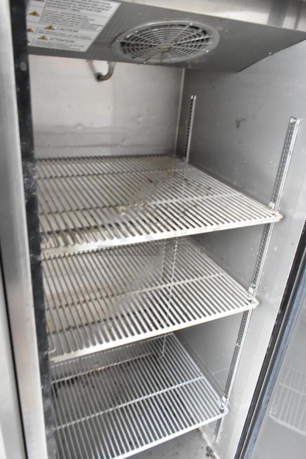 Interior view of a commercial-grade refrigerator with metal shelves, part of a 28' mobile Wendy's fast food trailer.