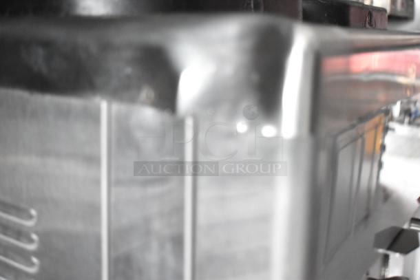 Blurry image of a fast food trailer's metal surface; details unclear.