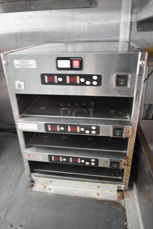 Commercial-grade Crisp N Hold system inside the Wendy's food trailer, featuring multiple digital control panels.