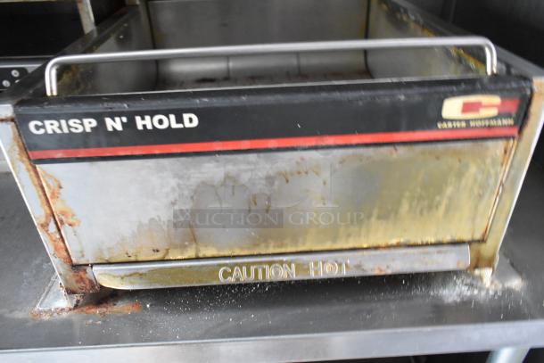 Carter-Hoffmann Crisp N' Hold food warmer showing signs of wear, prominently labeled "Caution Hot."