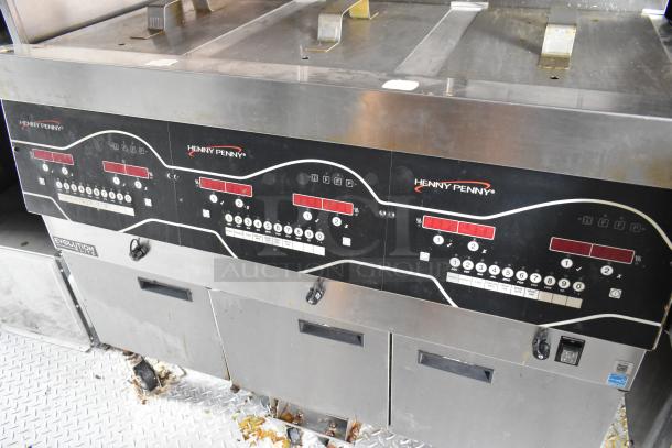 Henny Penny fryer controls on a 28' Wendy's mobile kitchen trailer, showcasing multiple cooking settings.
