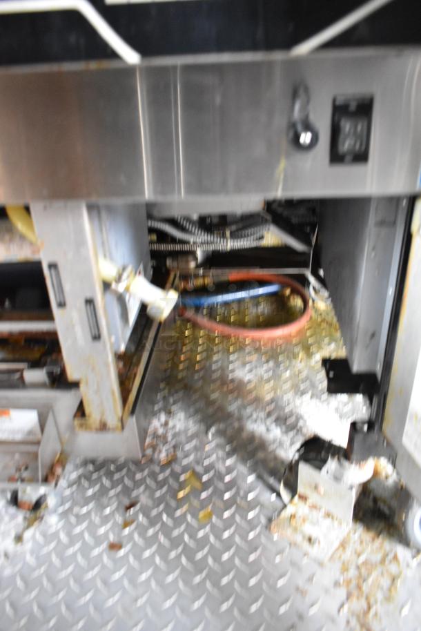 Interior view of 28' Wendy's fast food trailer, showing industrial kitchen equipment on a checker plate floor.