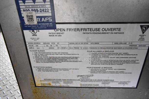 Henny Penny fryer label showing model EEG-253, power specs, and operation instructions. Tags indicate service info.