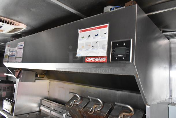 CaptiveAire grease hood in a 28' Wendy's fast food trailer, featuring stainless steel construction and installed signage.