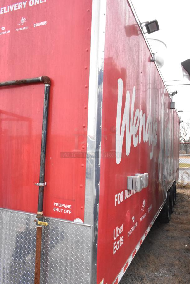 28' Wendy's fast food trailer with commercial equipment and delivery branding, equipped with a propane shut off valve.
