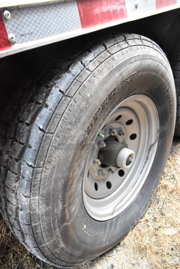 Close-up of a tire on a 28' fully outfitted Wendy's fast food trailer, showing "Super ST" marking on sidewall.