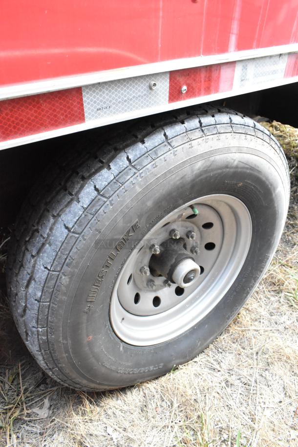 Close-up of a Westlake tire on a 28' Wendy's fast food trailer, part of a fully equipped mobile kitchen with commercial-grade appliances.
